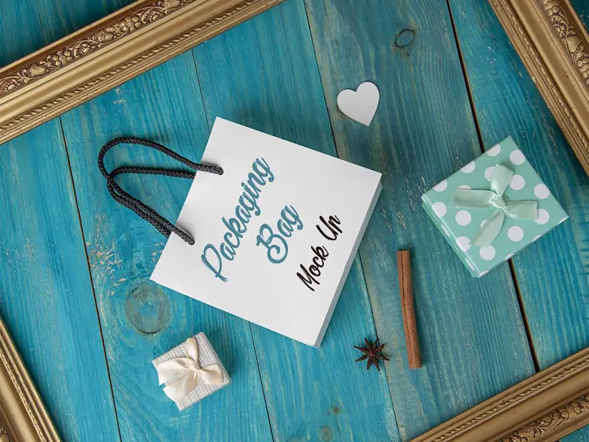 free gift bag mockup on a blue wooden background