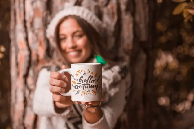 autumn concept with woman holding mug