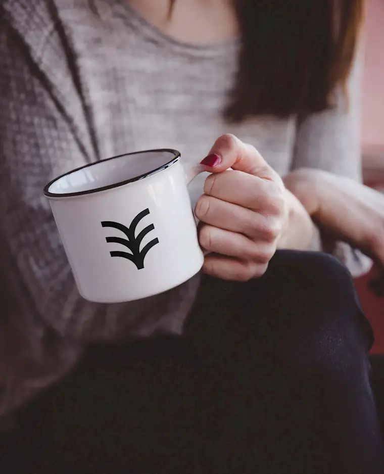 hand holding metal mug mockup