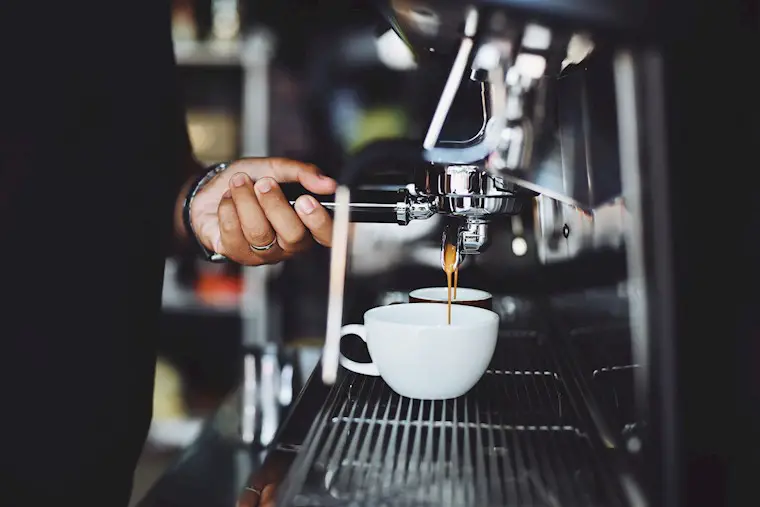 hand holding coffee machine background