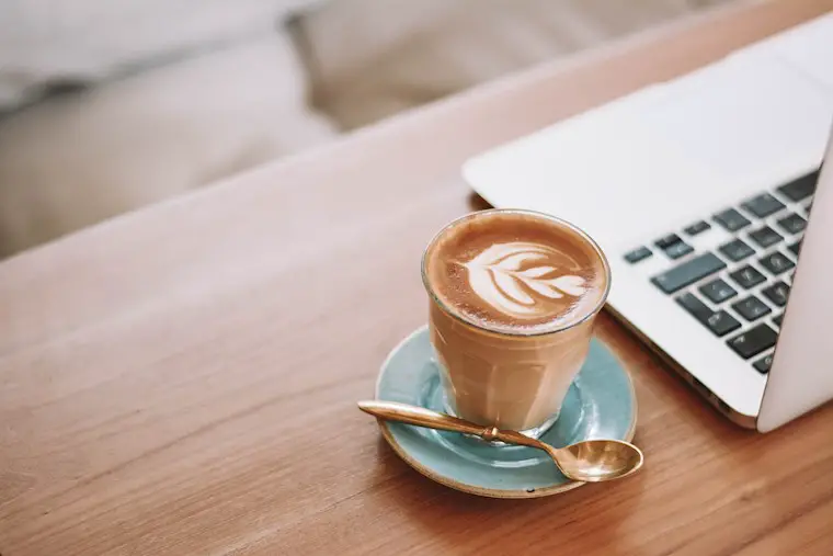macbook and latte on wooden table wallpaper