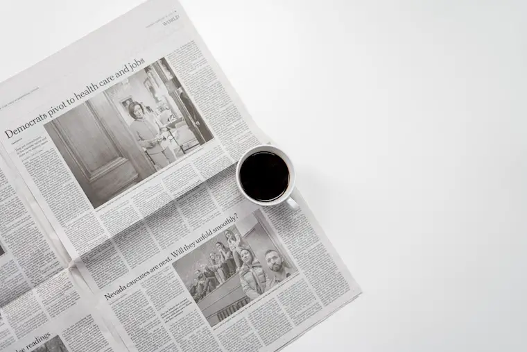 white mug on top of newspaper background